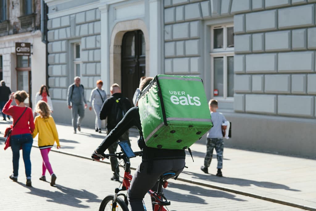 Backpacker qui fait une livraison Uber Eats sur son vélo dans la ville de Sydney en Australie.